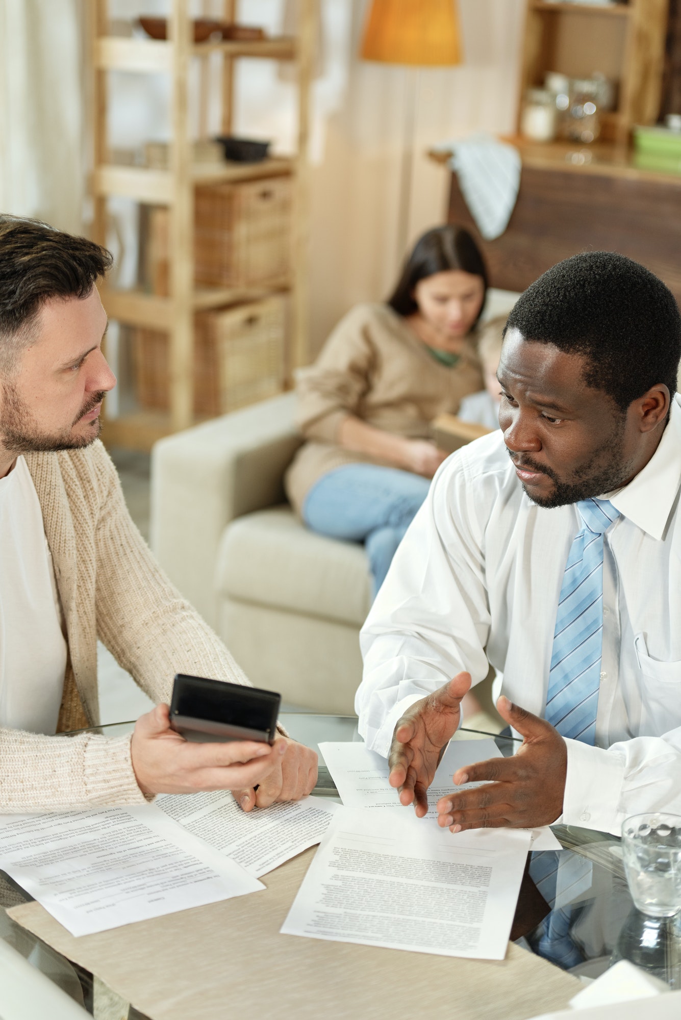 Black man helping client with loan calculation